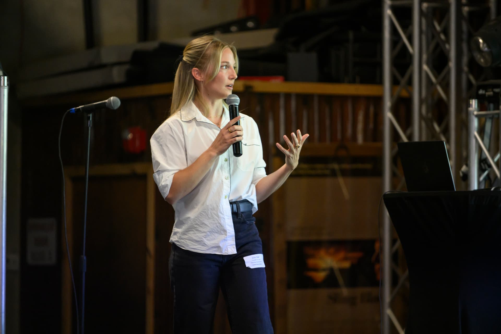 Julia Starr speaking with a microphone at the in-person Vibe Coding Workshop